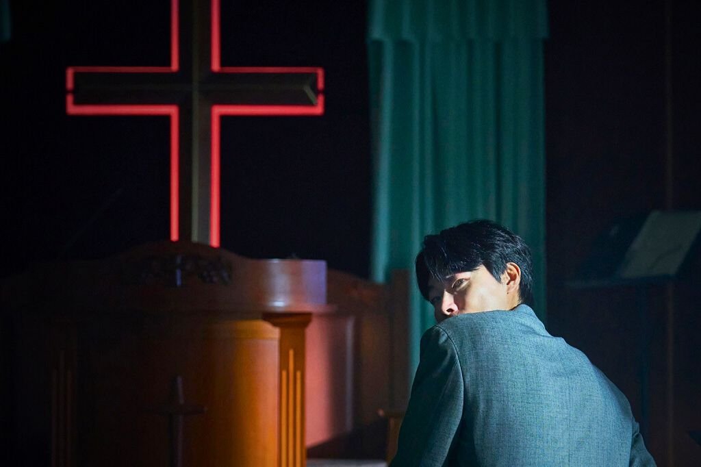 Dark church interior sets the tone for Revelations’ chilling exploration of faith and guilt.